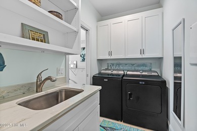 This gorgeous home in Kure Beach Village has 5 bedrooms, 5 1/2