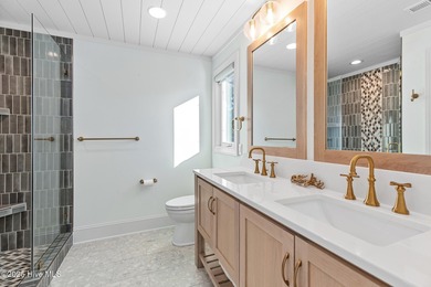 This gorgeous home in Kure Beach Village has 5 bedrooms, 5 1/2