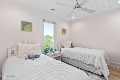 This gorgeous home in Kure Beach Village has 5 bedrooms, 5 1/2