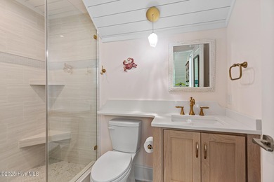 This gorgeous home in Kure Beach Village has 5 bedrooms, 5 1/2