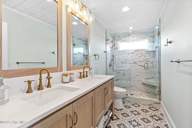 This gorgeous home in Kure Beach Village has 5 bedrooms, 5 1/2