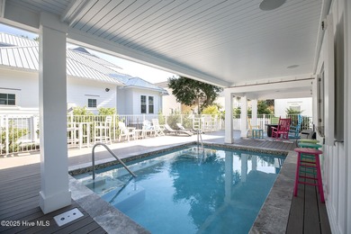 This gorgeous home in Kure Beach Village has 5 bedrooms, 5 1/2