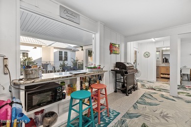 This gorgeous home in Kure Beach Village has 5 bedrooms, 5 1/2