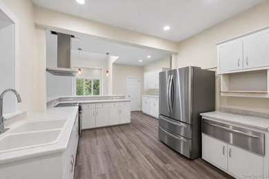 Set on a private 1.18-acre property in Hampton Bays, this - photo 16