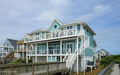 Nestled along a pristine stretch of coastline, this stunning