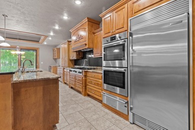 Well-maintained no-step home on a wooded cul-de-sac lot with