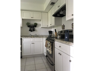 First-floor condo located in a gated golf community with a 24H - photo 3