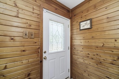 With its knotty pine wood finishes and tree shaded setting, this