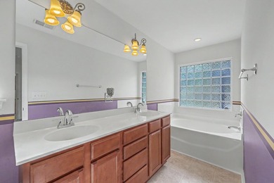 Nestled on a prime corner lot with serene pond views, this - photo 20