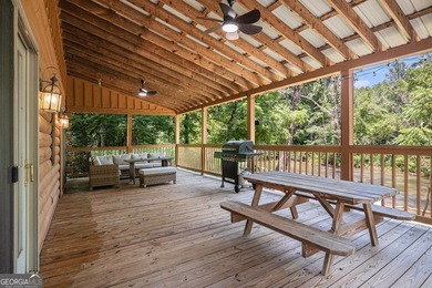 This beautiful log cabin home is located on the edge of the - photo 12