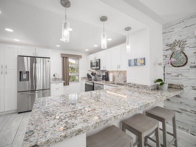Beautiful and fully remodeled end unit that sits south of the - photo 2