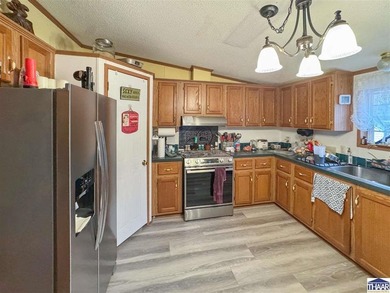 Nestled at the end of a quiet lane on 2 private acres, this