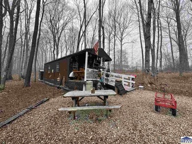 Nestled at the end of a quiet lane on 2 private acres, this