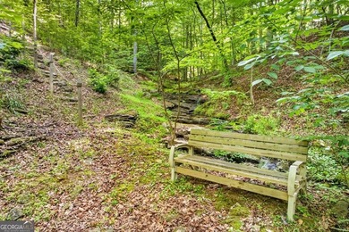 Fully furnished true log home on 5.78 private wooded acres in - photo 47