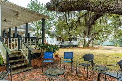 Tucked beneath a canopy of majestic live oaks along the serene - photo 6