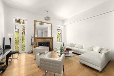327 East 18th Street is a 20-foot-wide townhouse on one of - photo 1