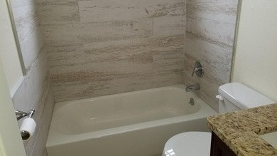 This updated ground floor unit features closed in porch; - photo 11