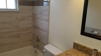 This updated ground floor unit features closed in porch; - photo 12