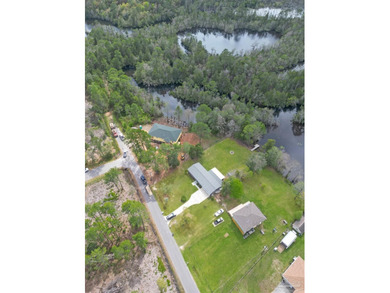 Set along 99 feet of watererfront, this updated brick home - photo 43