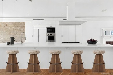 A fully renovated two-family townhouse spanning approximately 3 - photo 5