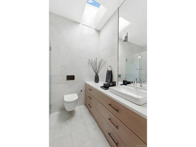 A fully renovated two-family townhouse spanning approximately 3 - photo 10
