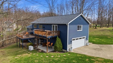 Escape to this impeccably maintained lakefront retreat in the - photo 1