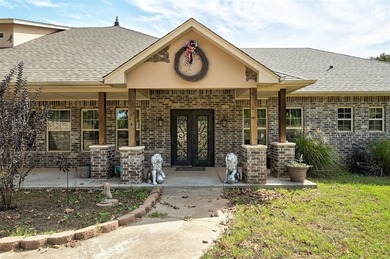 Tucked away on a stunning 2.5-acre wooded lot, this nearly 3,500