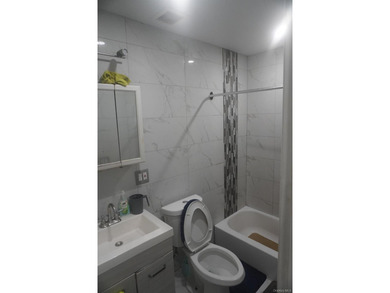 Beautifully newly renovated two-family frame house featuring a - photo 8