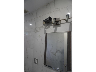 Beautifully newly renovated two-family frame house featuring a - photo 9