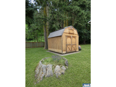 Tucked among mature trees and lovingly maintained, this inviting - photo 14