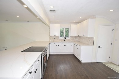 The stunning brand-new eat-in kitchen is the heart of the home - photo 7