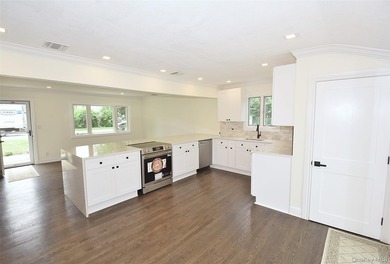 The stunning brand-new eat-in kitchen is the heart of the home - photo 8