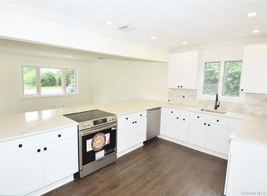 The stunning brand-new eat-in kitchen is the heart of the home - photo 9