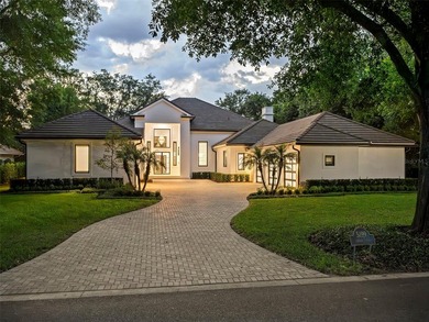 Set within the gates of renowned Isleworth, this beautifully - photo 1
