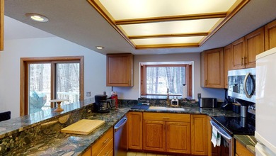 Step into this warm and inviting 3-bedroom, 2-bath chalet - photo 13
