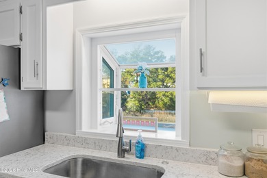 Pull up to your nautical blue piling home on Pine Island and