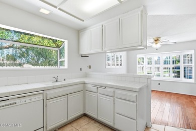 Highly desirable Cape Cod single story end unit! This charming