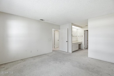 Highly desirable Cape Cod single story end unit! This charming