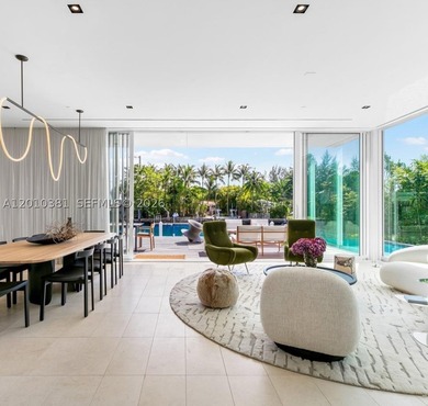This one-of-a-kind, two-story waterfront villa, designed by - photo 2