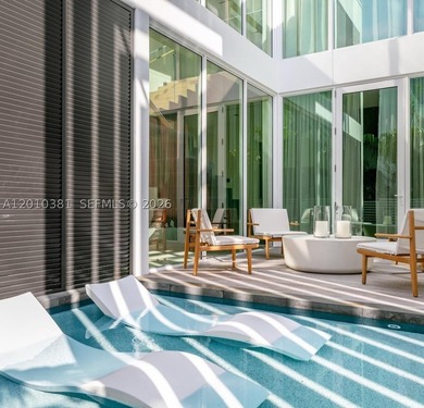 This one-of-a-kind, two-story waterfront villa, designed by - photo 4