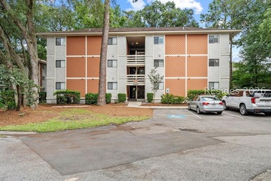 Tucked among mature landscaping in the highly desirable gated - photo 1
