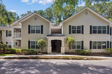 Enjoy wooded views from this second-floor condominium in The - photo 1