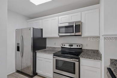Enjoy wooded views from this second-floor condominium in The - photo 7