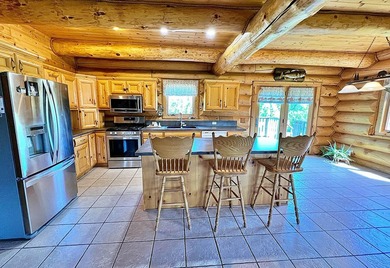 Authentic log cabin retreat on 80 picturesque acres featuring a - photo 6