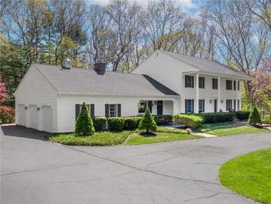 A circular driveway welcomes you to this elegant Colonial set on - photo 1