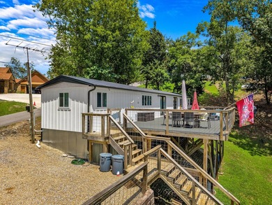 Welcome home to this charming, fully updated lake retreat on - photo 1