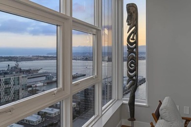 Perched high on the 27th floor, this rare end unit residence at - photo 1