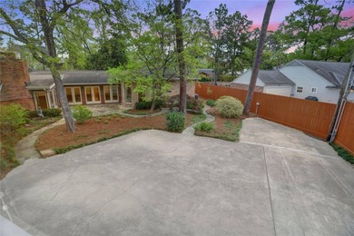 Tucked beneath towering mature trees, this sprawling ranch home - photo 17