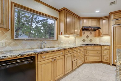 Tucked beneath towering mature trees, this sprawling ranch home - photo 36
