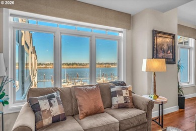 Experience elevated riverfront living in this top-floor